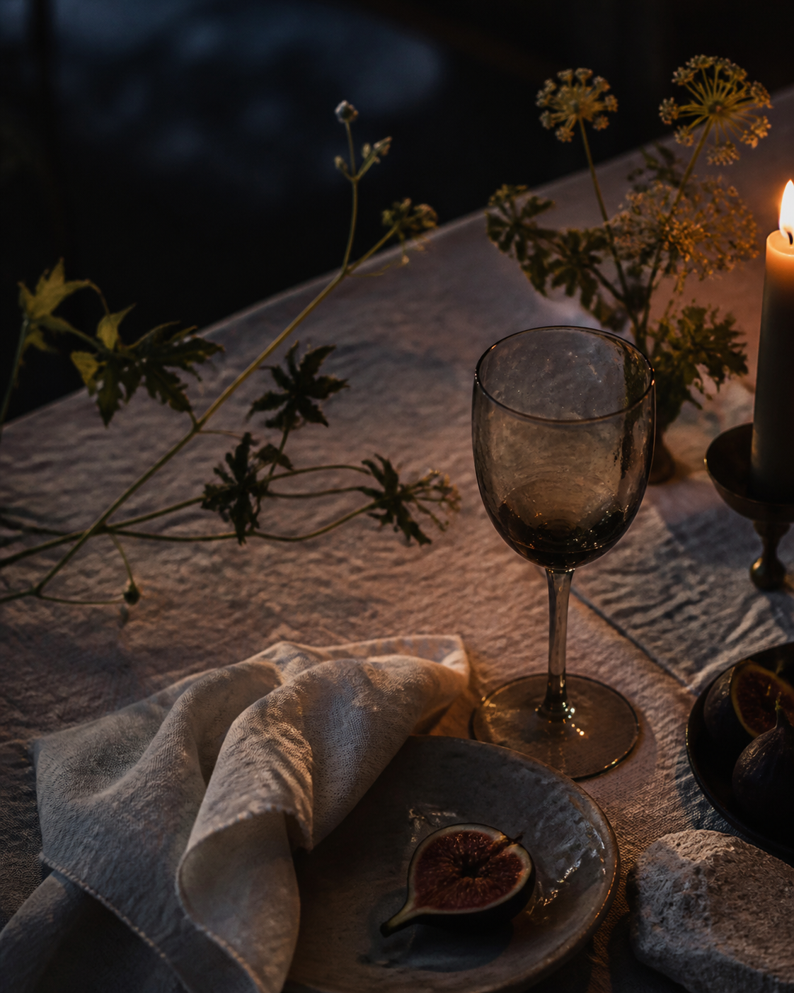 Fig, handblown glass and candlelight on ivory linen